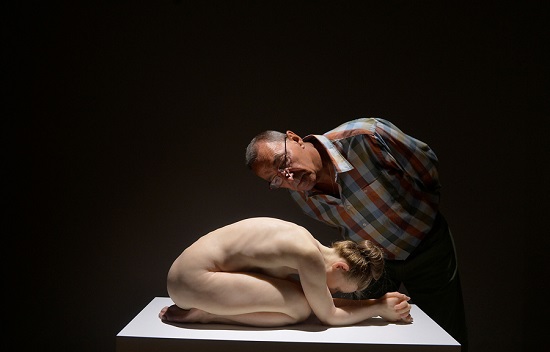 A visitor observes the sculpture 